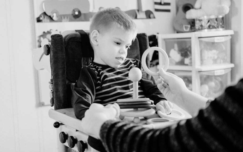 A child with cerebral palsy works with therapist to improve movement and coordination.