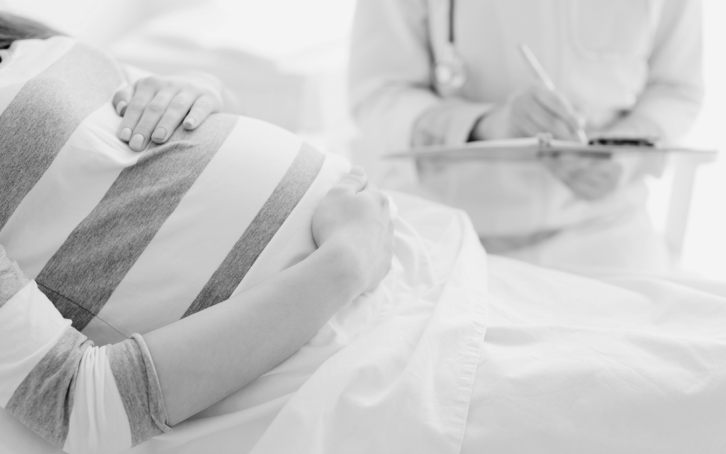 Doctor closely monitors woman's pregnancy.