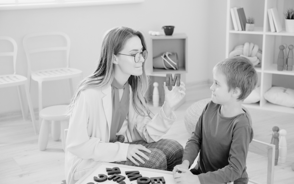 A child working with a speech therapist, practicing speaking and communication skills.